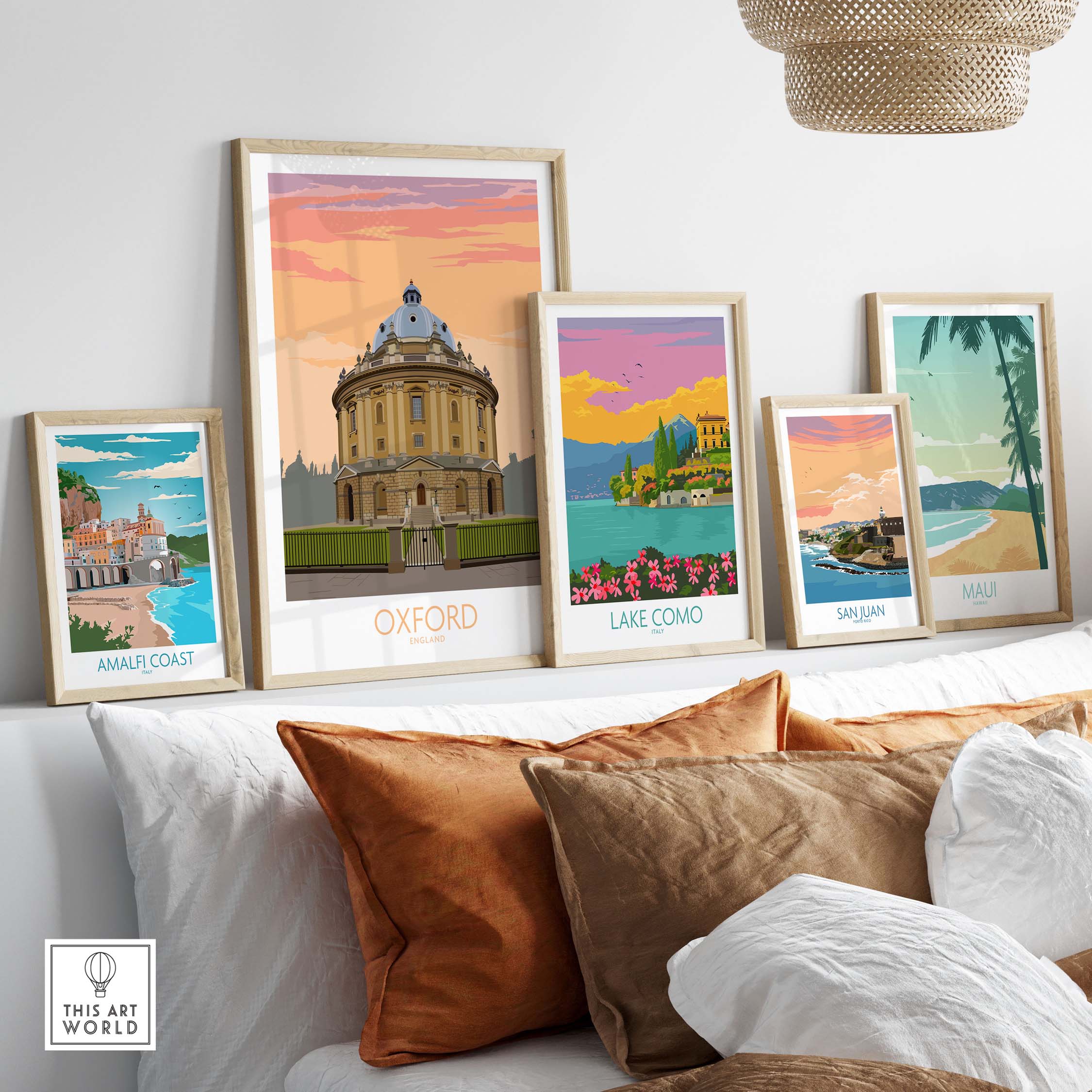 Framed Oxford travel poster and other vintage-style art prints on a stylish sofa.