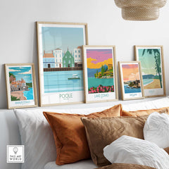 Framed vintage travel poster prints including Poole, Lake Como, and Amalfi Coast in a stylish home setting.