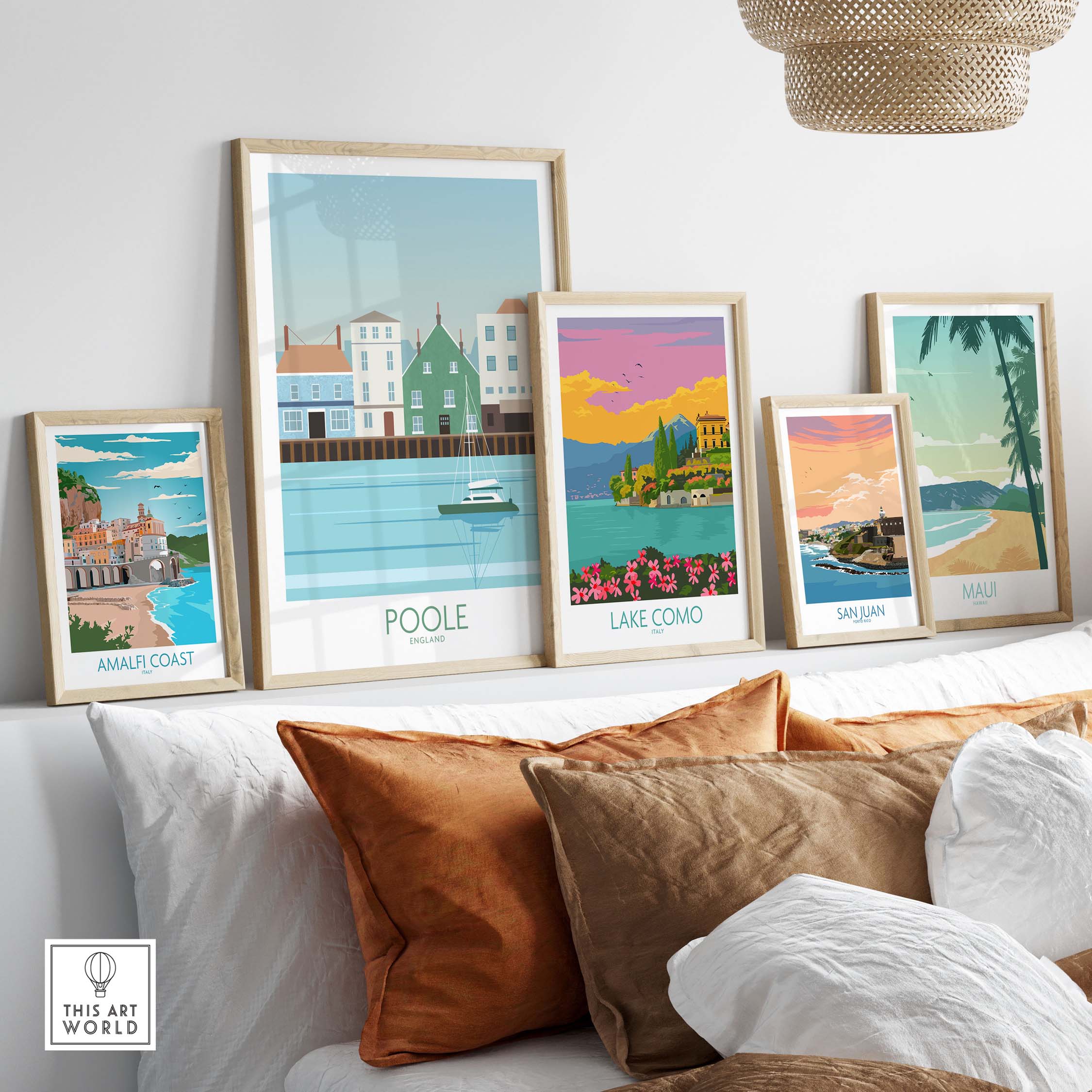 Framed vintage travel poster prints including Poole, Lake Como, and Amalfi Coast in a stylish home setting.