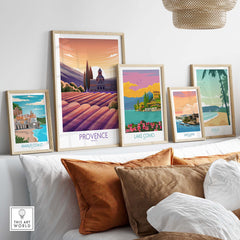 Framed travel posters featuring Provence, Lake Como, Amalfi Coast, San Juan, and Maui displayed in a stylish home setting.
