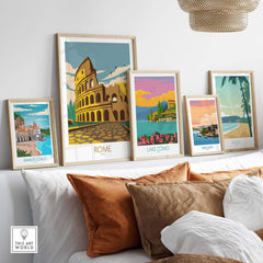 Vintage Rome travel poster collection displayed above a cozy couch, showcasing the Colosseum and scenic Italian landscapes.