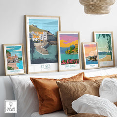 Framed Cornwall Poster St Ives Print among other vintage travel art pieces on a stylish sofa.