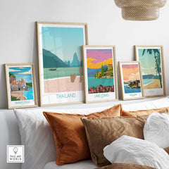 A collection of travel posters featuring Thailand, Amalfi Coast, Lake Como, San Juan, and Maui displayed in stylish frames.
