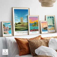Framed travel poster prints including The Cotswolds, Lake Como, Amalfi Coast, San Juan, and Maui on a stylish wall.