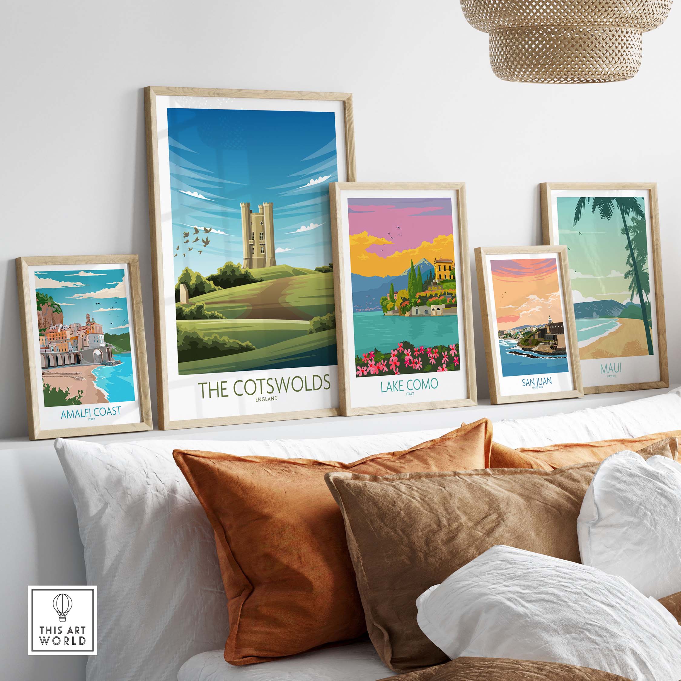 Framed travel poster prints including The Cotswolds, Lake Como, Amalfi Coast, San Juan, and Maui on a stylish wall.