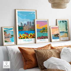 Collection of vintage travel posters including The Hague, Lake Como, and Amalfi Coast displayed in a stylish home setting.