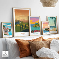Framed Tuscany and Italian travel art prints displayed on a shelf in a cozy home setting.