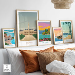 Vienna Wall Art Print and vintage travel posters displayed on a sofa, showcasing travel-inspired artwork decorations.