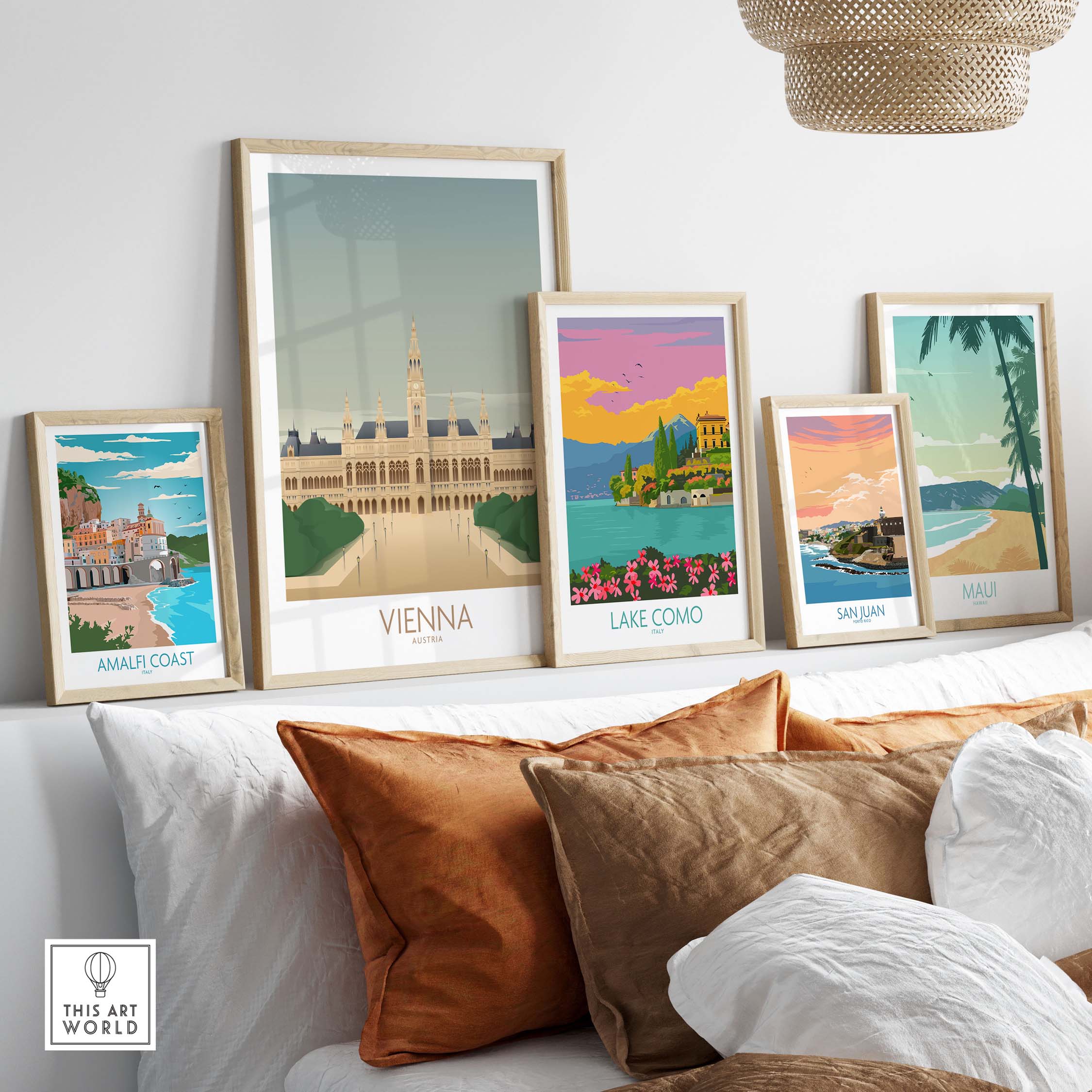 Vienna Wall Art Print and vintage travel posters displayed on a sofa, showcasing travel-inspired artwork decorations.