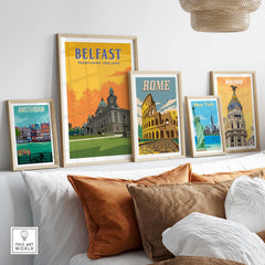Framed travel posters of Belfast, Rome, Madrid, and Amsterdam displayed in a stylish living room setting.