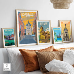 Bordeaux poster print among framed travel posters of Amsterdam, Rome, New York, and Madrid on a stylish wall.
