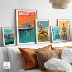 Brighton vintage travel poster wall art in stylish frames on a shelf with Amsterdam, Rome, New York, and Madrid prints.