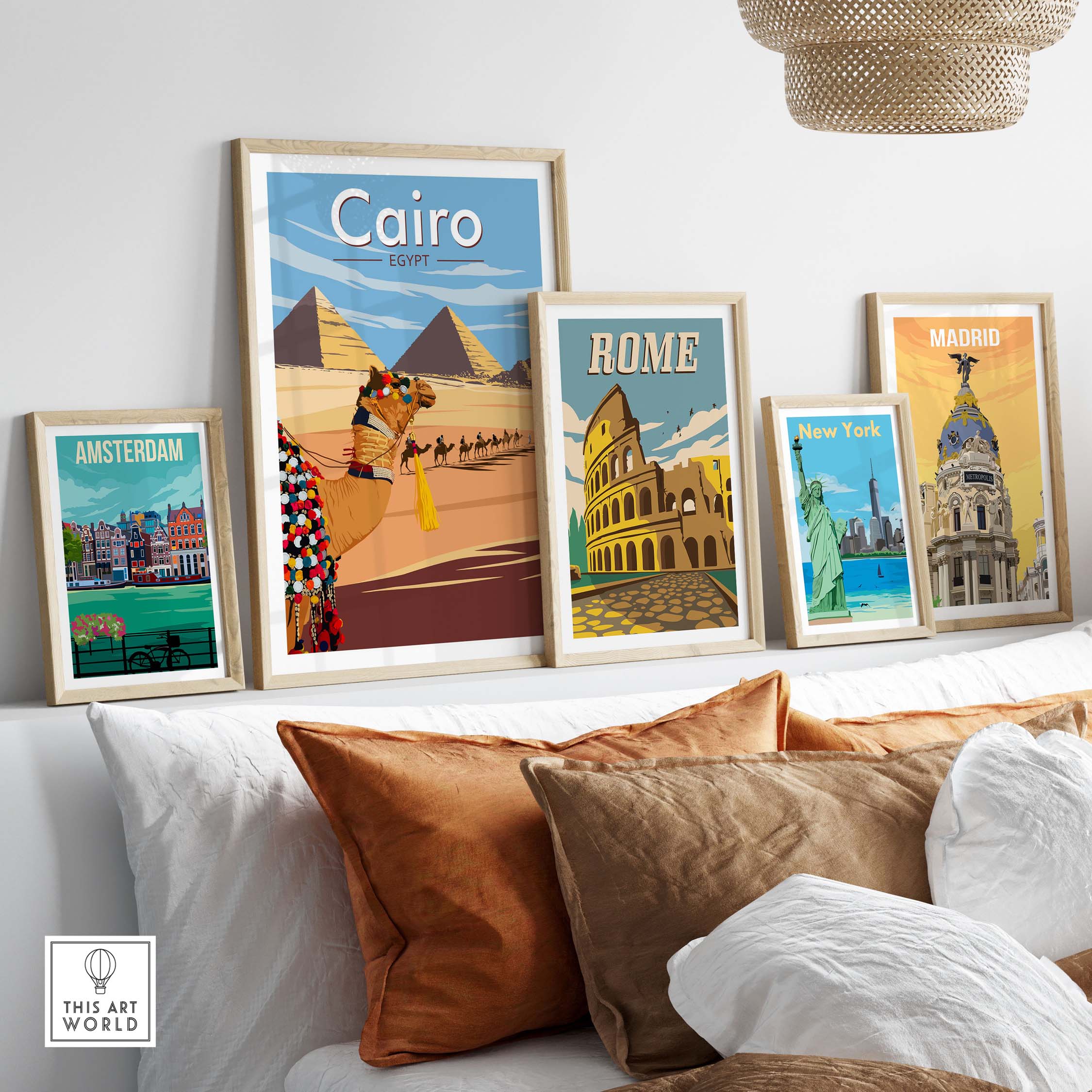 Cairo Wall Art Print among framed travel posters of Amsterdam, Rome, New York, and Madrid on a stylish couch.