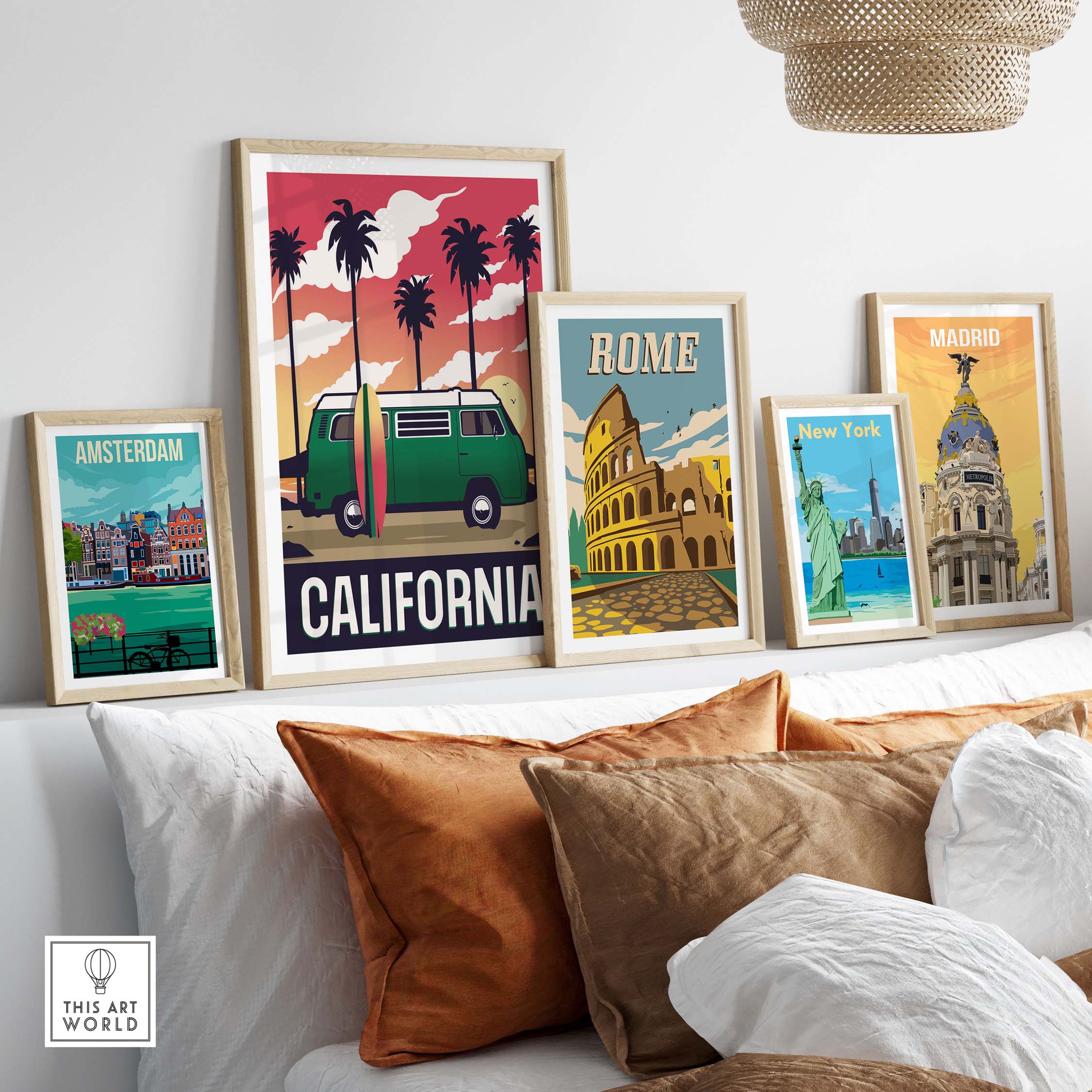 California travel poster wall art with framed prints of Amsterdam, Rome, New York, and Madrid on a couch.