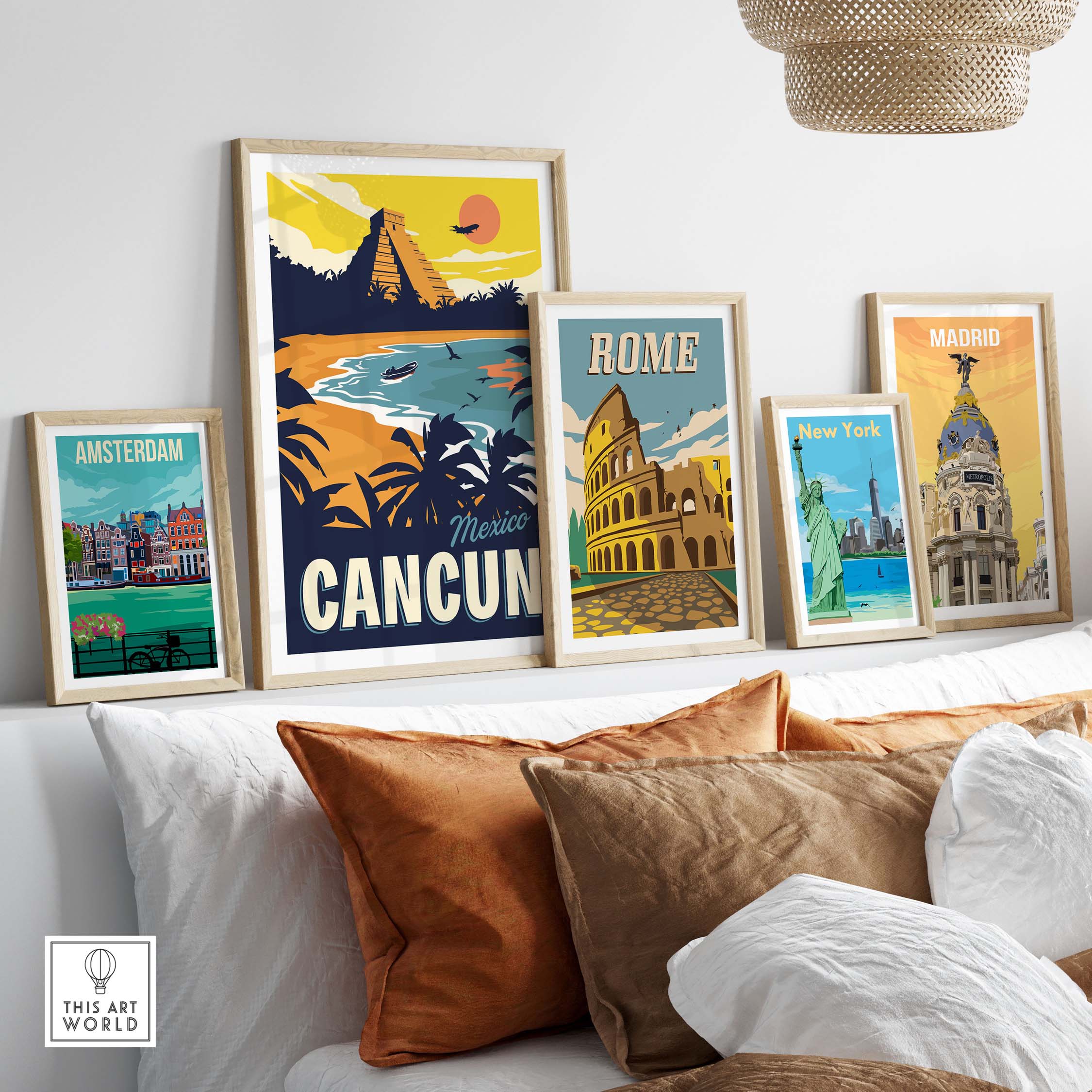 Framed vintage travel posters, including Cancun, Amsterdam, Rome, and New York, displayed on a stylish sofa.