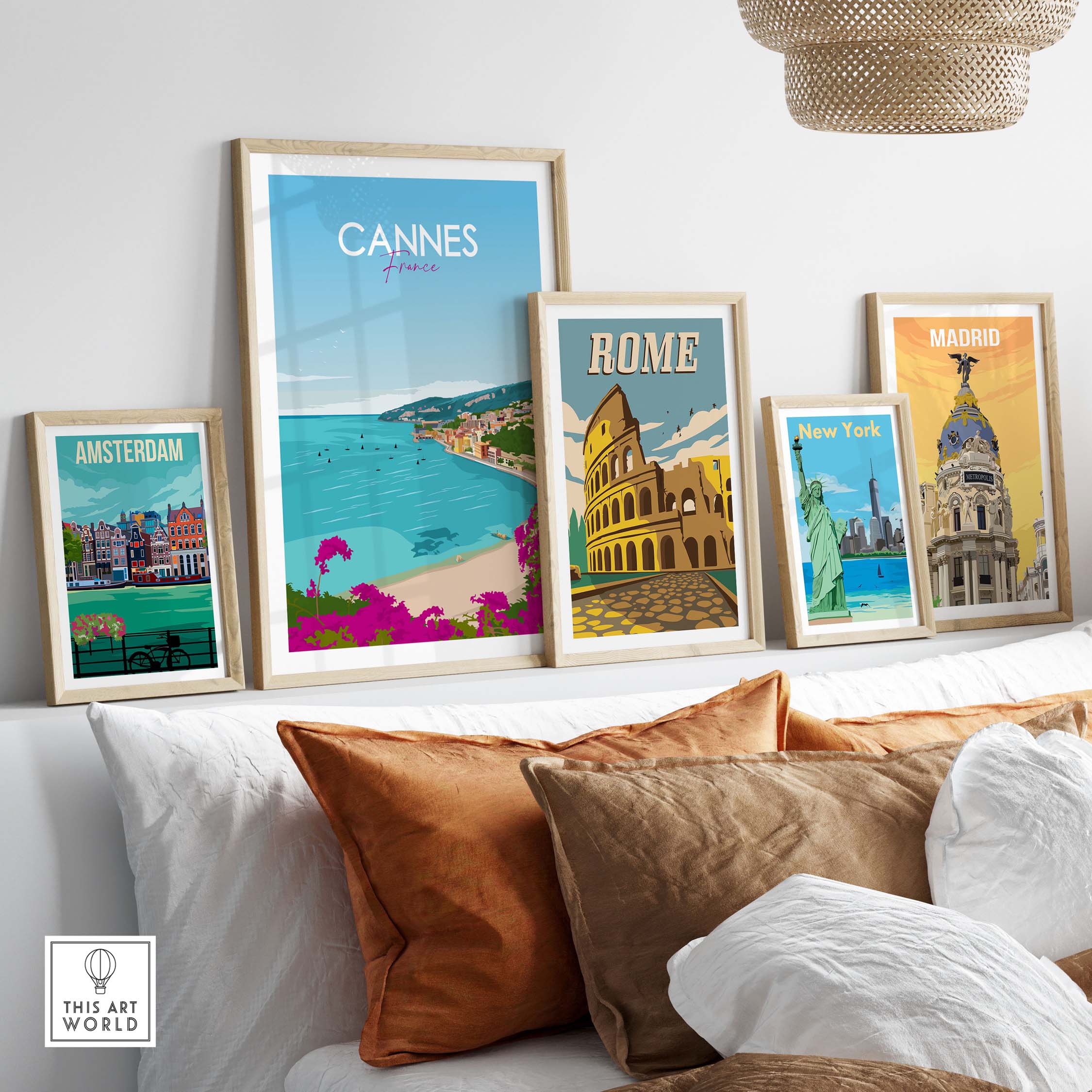 Stylish travel poster prints of Cannes, Rome, Amsterdam, and Madrid displayed in a modern home setting.
