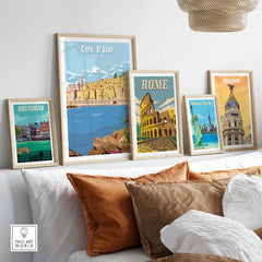 Cote d'Azur, Amsterdam, Rome, New York, and Madrid vintage travel posters displayed on a stylish couch.