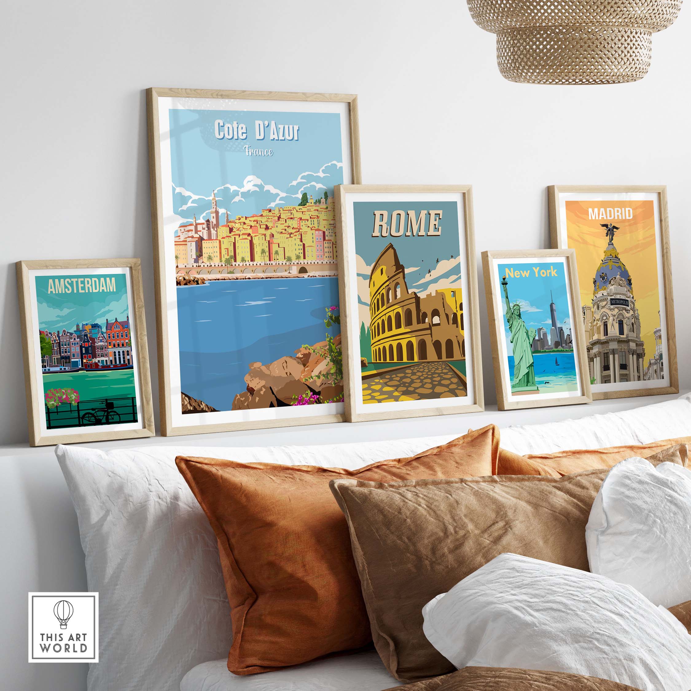 Cote d'Azur, Amsterdam, Rome, New York, and Madrid vintage travel posters displayed on a stylish couch.