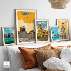 Framed vintage travel posters of Crete, Rome, Amsterdam, and Madrid on a stylish sofa.