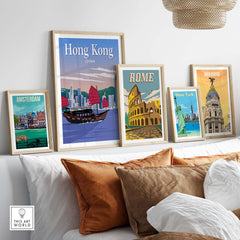 Framed travel poster prints featuring Hong Kong, Rome, Madrid, New York, and Amsterdam in a stylish interior setting.