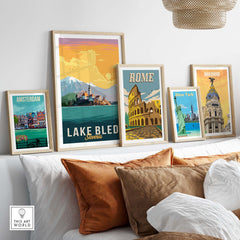 Lake Bled Print Slovenia displayed among framed travel posters, featuring iconic cityscapes like Rome and Amsterdam.