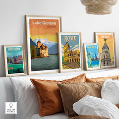 Lake Geneva Poster Switzerland Print showcased among other vintage travel posters on a cozy couch.