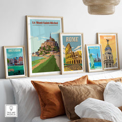 Framed vintage travel posters including Le Mont Saint Michel, Rome, Madrid, and Amsterdam displayed in a stylish interior.