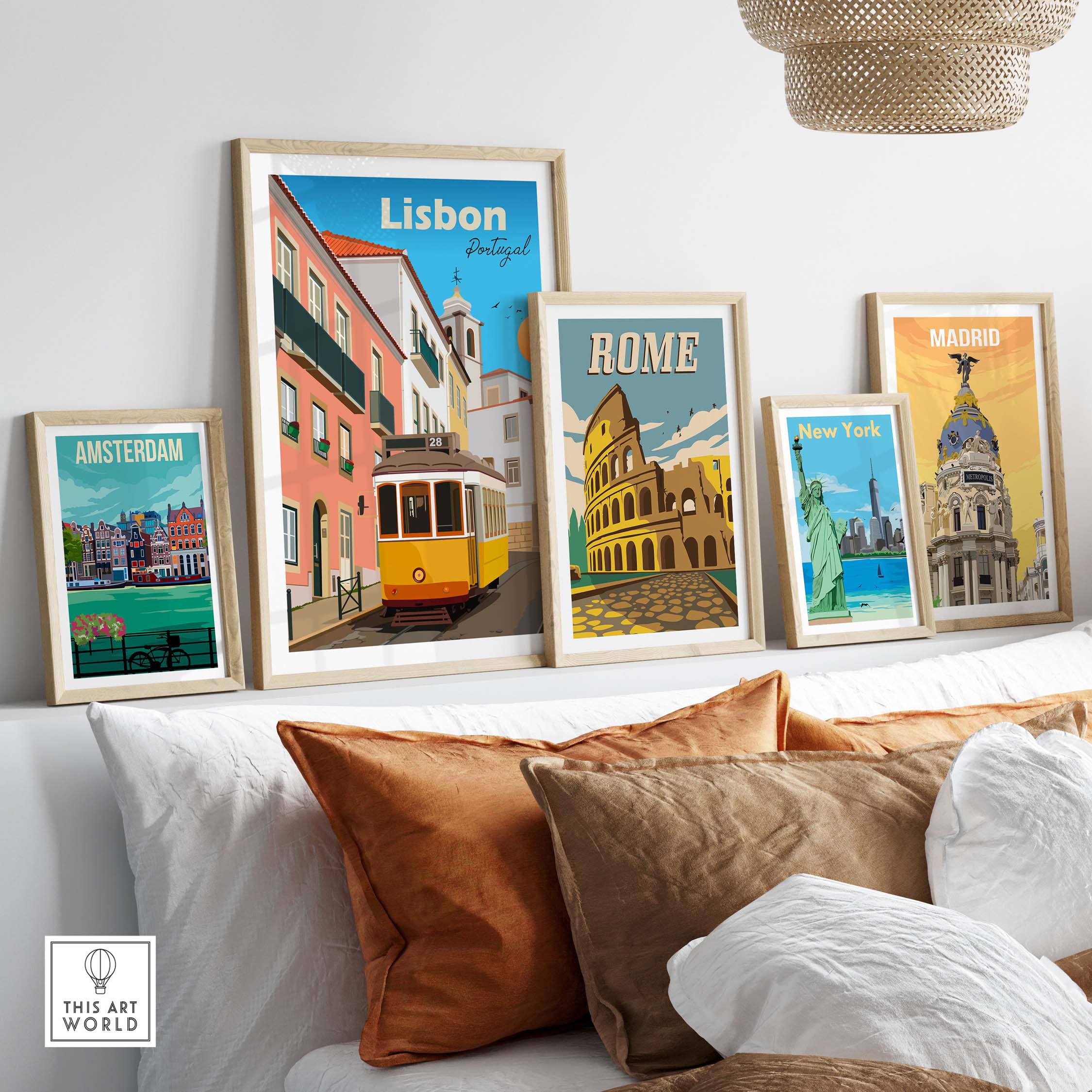 Lisbon travel poster print with framed artworks of famous cities like Rome, Amsterdam, and New York displayed on a stylish sofa.