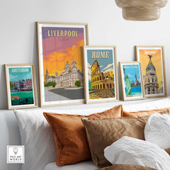 Stylish Liverpool poster and vintage travel art displayed in frames on a wall, enhancing home decor.