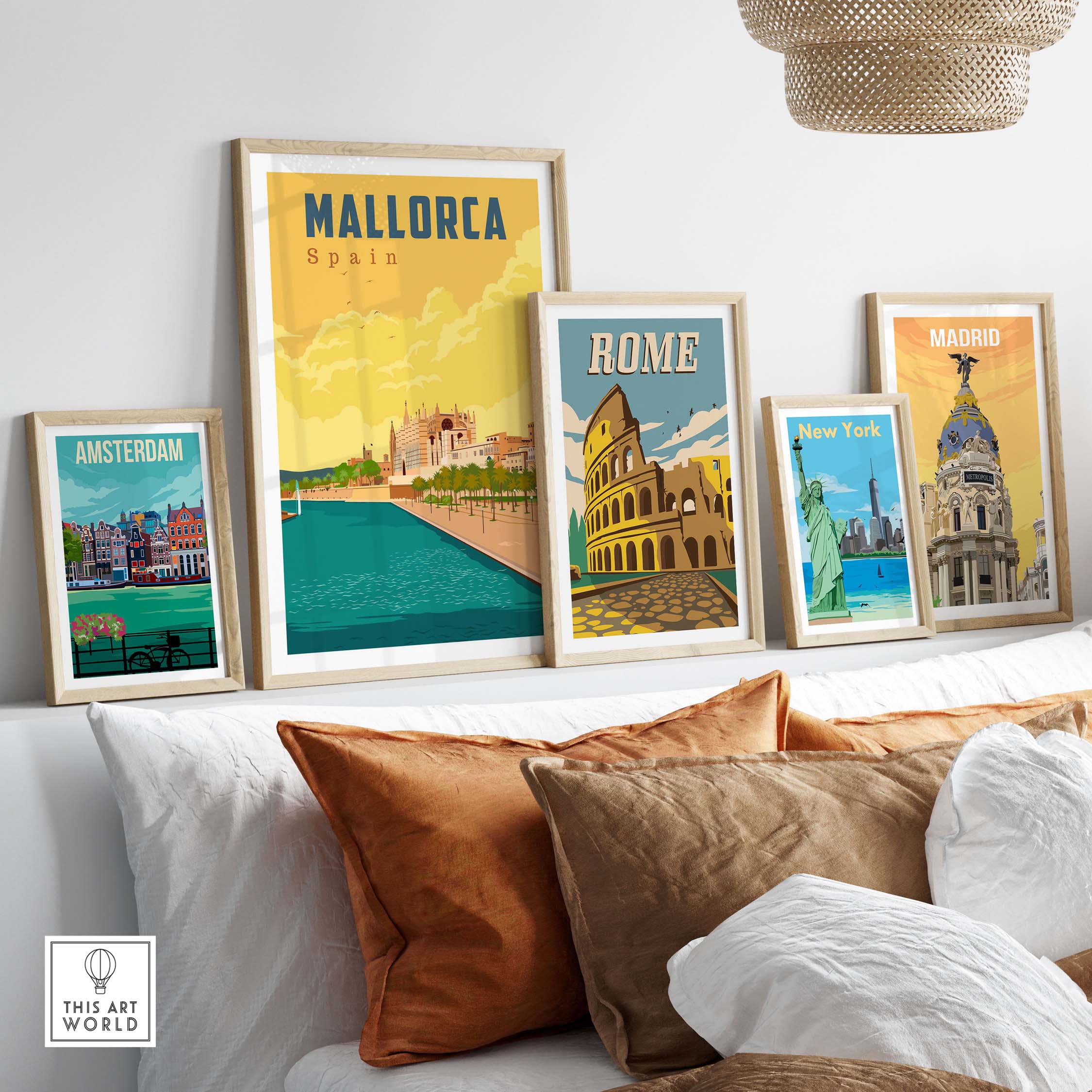 Framed vintage travel posters of Mallorca, Rome, Madrid, Amsterdam, and New York displayed on a shelf.