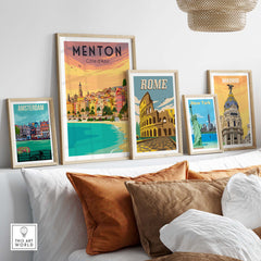 Framed vintage travel posters including Menton, Rome, Amsterdam, and Madrid displayed in a stylish living room setting.