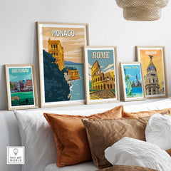 Monaco Wall Art Print displayed among vintage travel posters in a stylish home setting with decorative cushions.