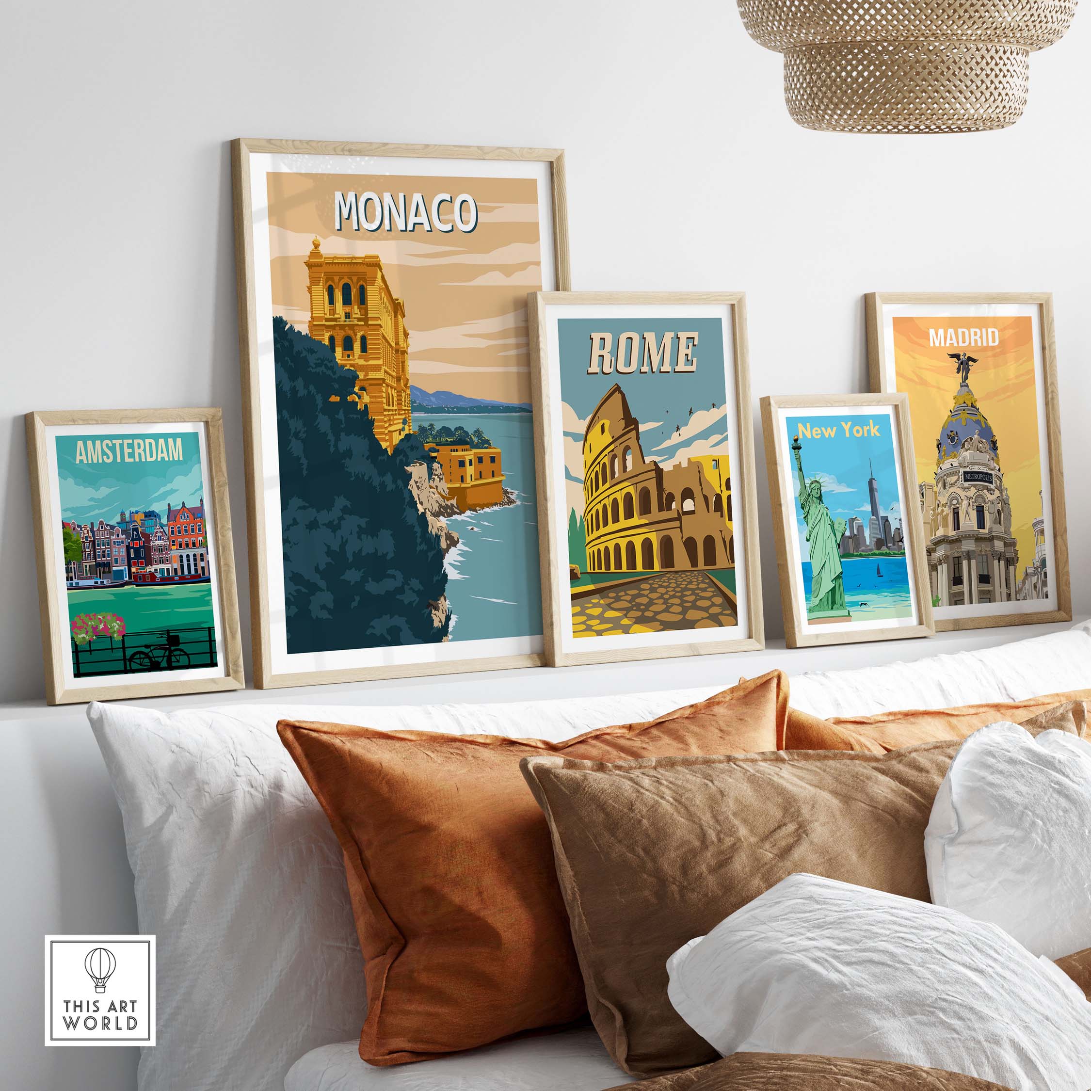 Monaco Wall Art Print displayed among vintage travel posters in a stylish home setting with decorative cushions.