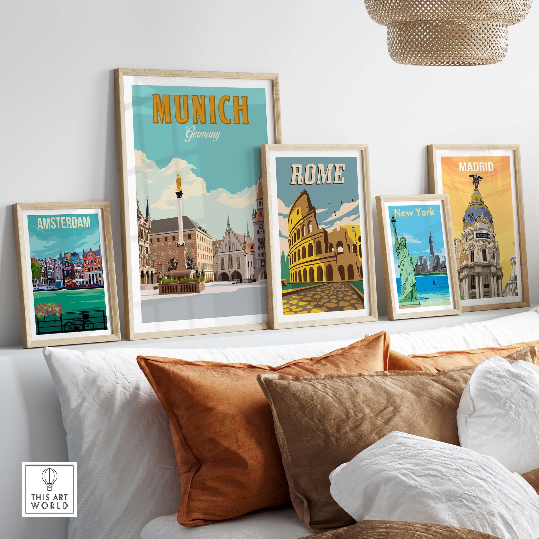 Munich Germany print displayed with framed travel posters of Amsterdam, Rome, and Madrid on a cozy sofa.
