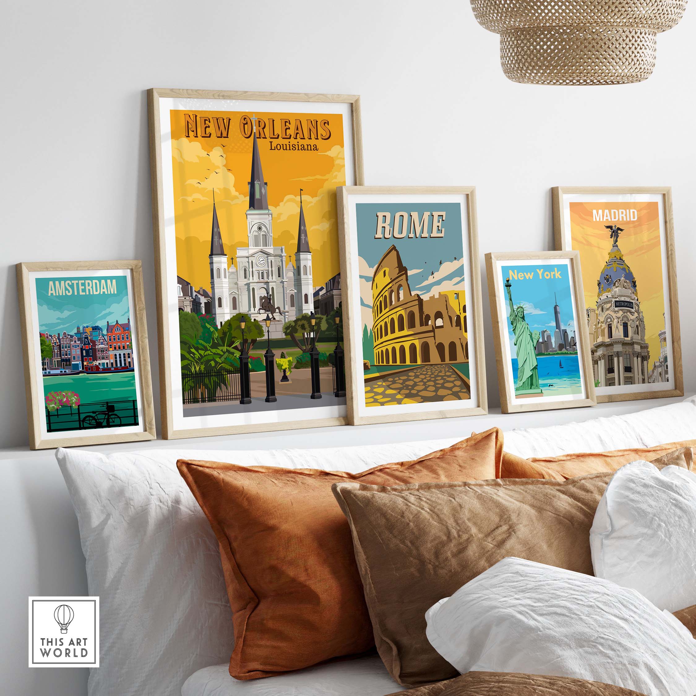 Vintage travel posters of New Orleans, Rome, Madrid, and Amsterdam displayed in stylish frames on a cozy living room couch.