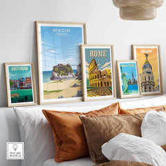 Newquay Print Cornwall Poster alongside framed travel posters of Amsterdam, Rome, and Madrid in a stylish home setting.