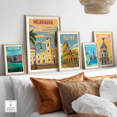 Nicaragua and travel posters displayed in stylish frames on a cozy sofa setting, showcasing vintage travel art.