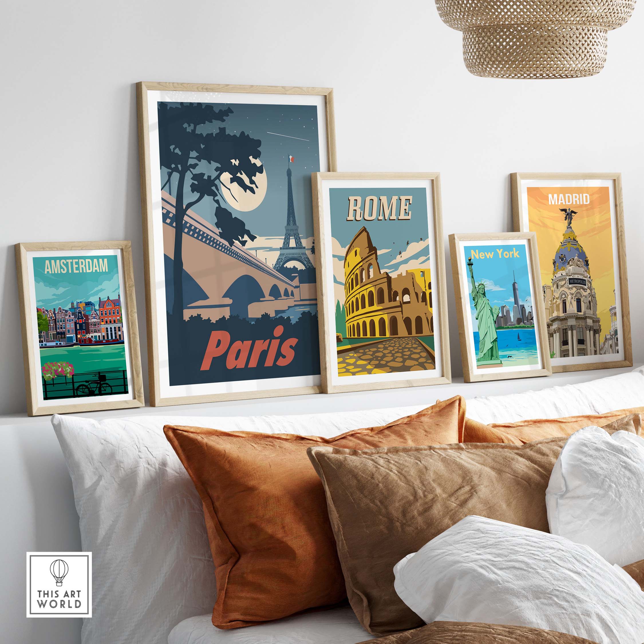 Paris poster wall art print displayed among framed travel prints of Amsterdam, Rome, New York, and Madrid on a stylish sofa.