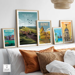 Framed Peak District National Park poster among travel-themed art prints displayed in a stylish living room setting.