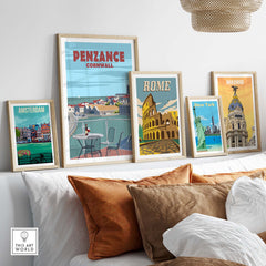 Penzance Cornwall poster print displayed with vintage travel art in a stylish living room setting.