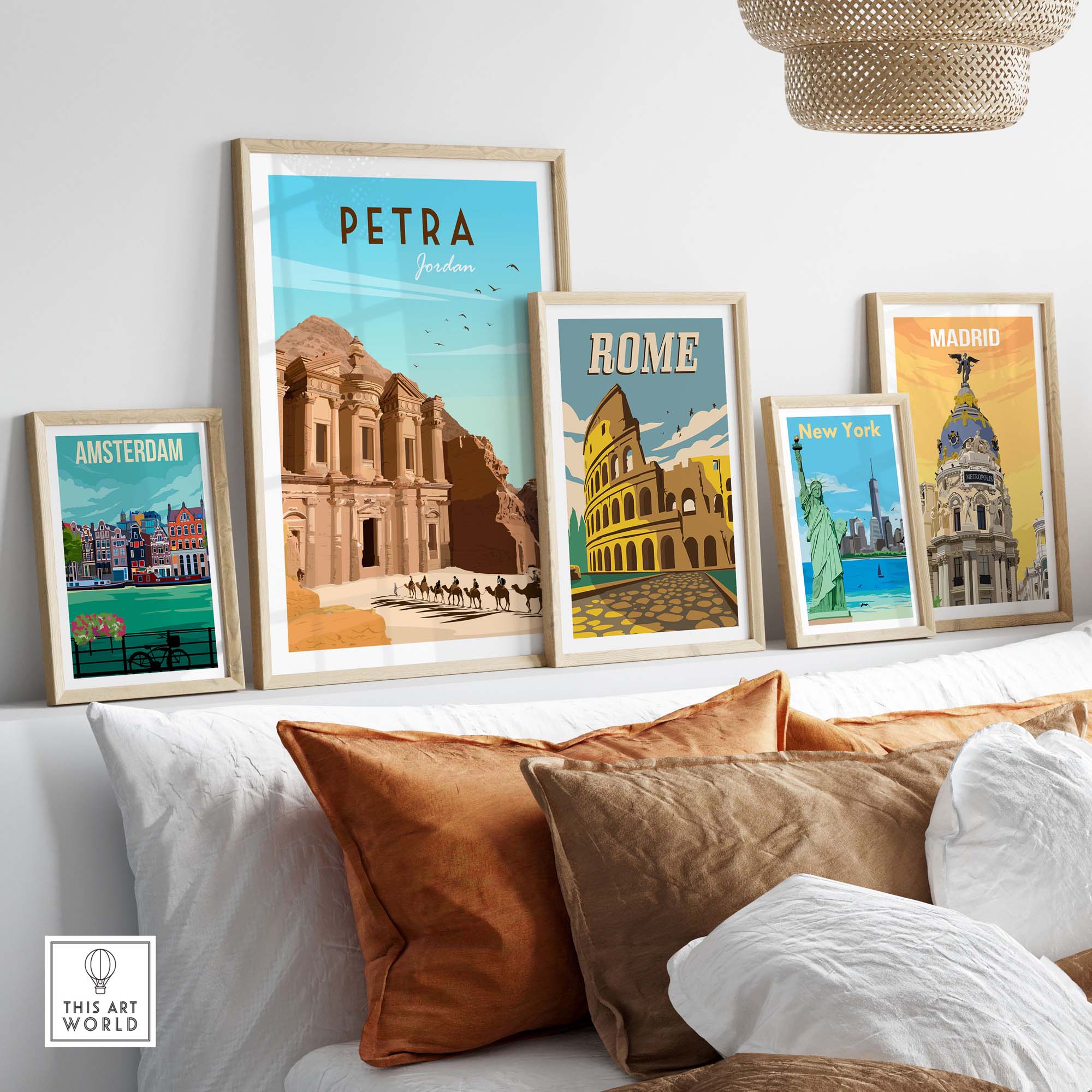 Petra travel poster print and other vintage travel art framed on a wall above a sofa in a stylish living room.