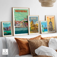 Collection of framed vintage travel posters including Porto Portugal, Rome, Amsterdam, and Madrid in a stylish living room setting.