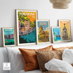 Framed vintage travel posters including Portofino, Rome, Madrid, Amsterdam, and New York displayed on a stylish shelf.