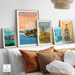 Decorative wall art featuring vintage travel posters of Puerto Rico, Amsterdam, Rome, and Madrid.