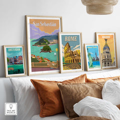 San Sebastian Spain poster print among framed vintage travel art from Amsterdam, Rome, and Madrid in a stylish home setting.