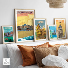 Stylish framed travel posters featuring Scheveningen, Amsterdam, Rome, New York, and Madrid in a modern home setting.