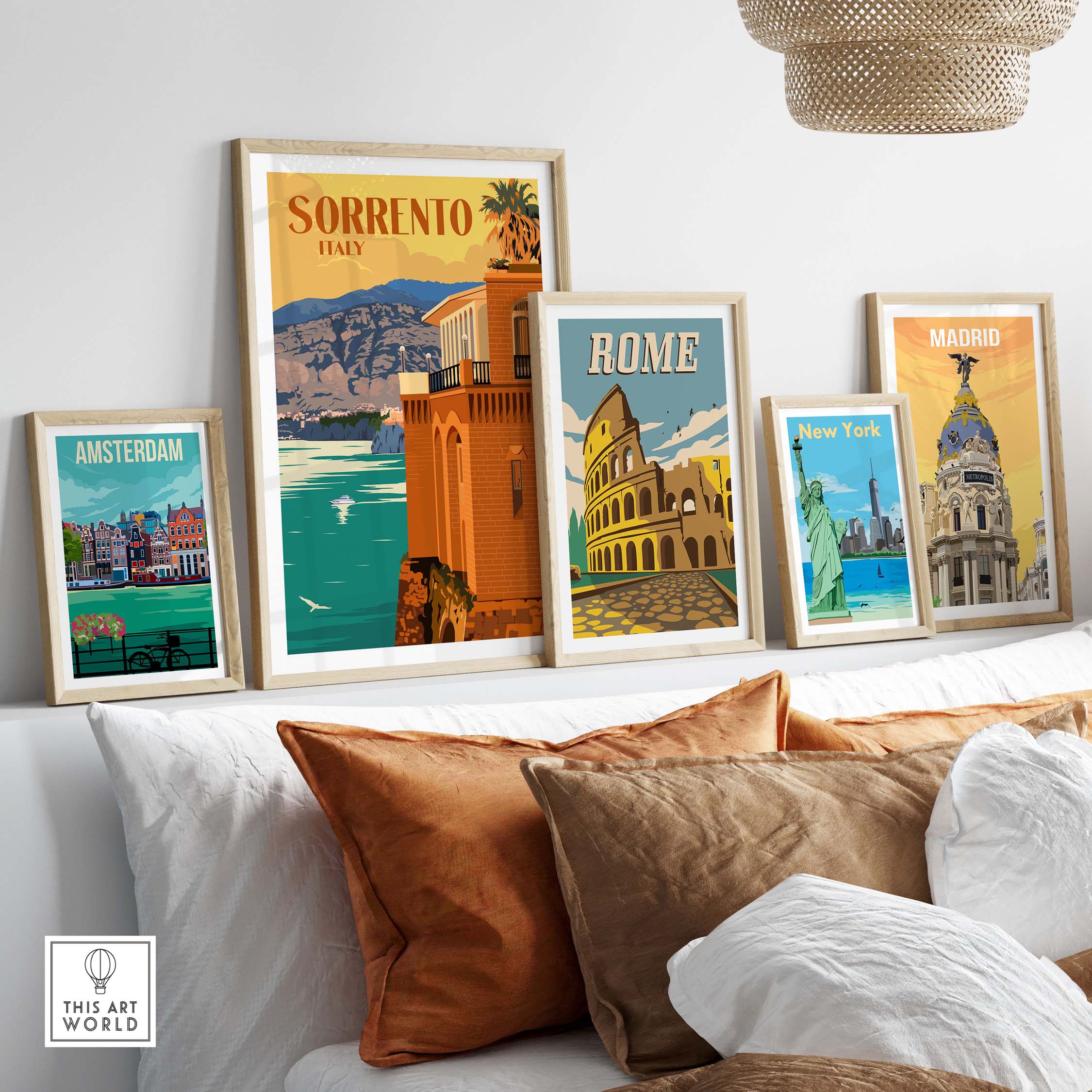 Collection of travel posters including Sorrento, Rome, Amsterdam, New York, and Madrid styled on a cozy shelf.
