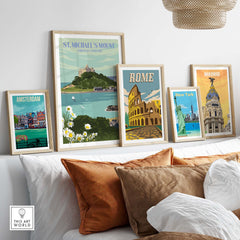 Framed St Michael's Mount print and vintage travel posters on a stylish wall, showcasing travel destinations.