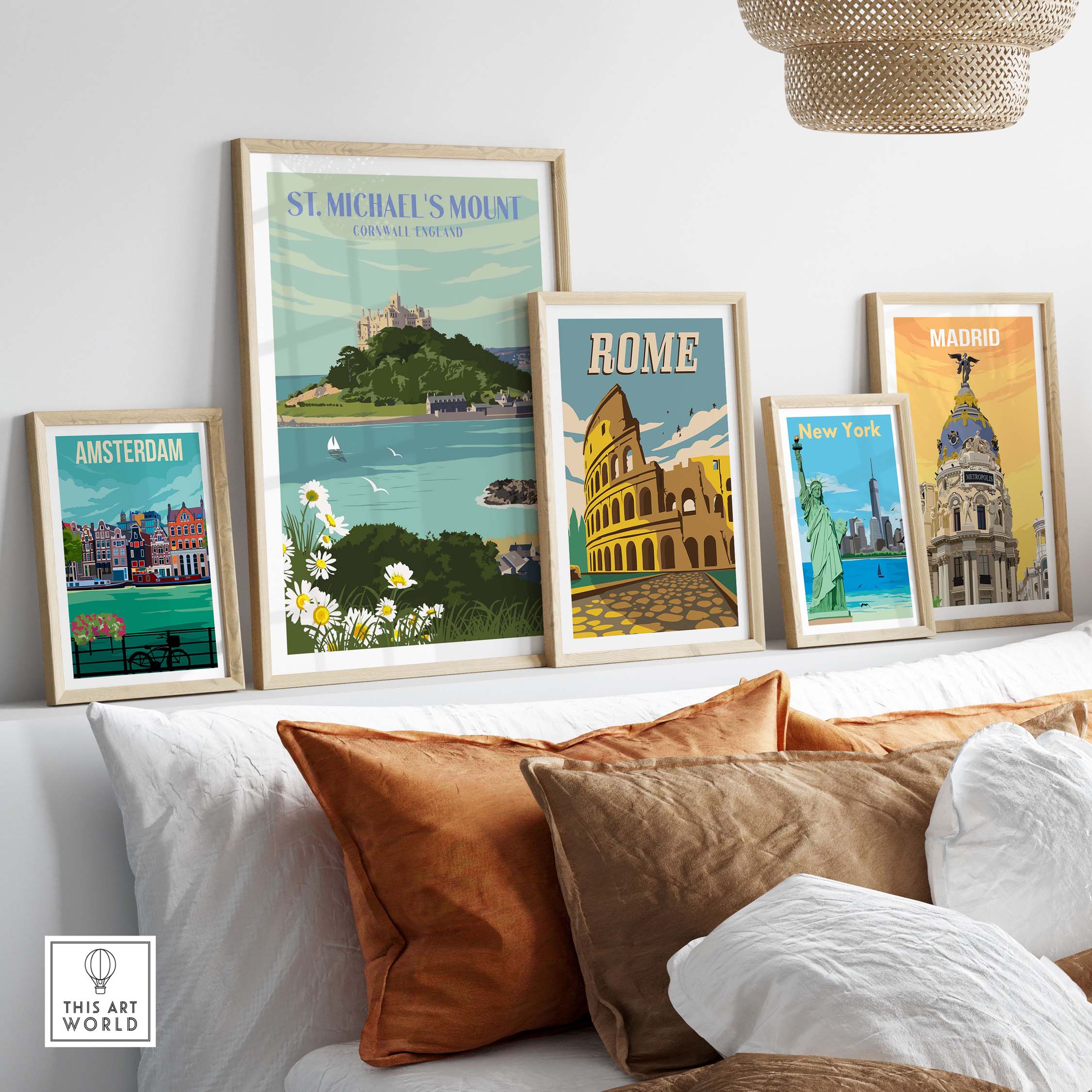 Framed St Michael's Mount print and vintage travel posters on a stylish wall, showcasing travel destinations.