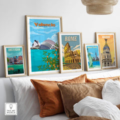 Collection of vintage wall art prints featuring Valencia, Rome, Amsterdam, New York, and Madrid on a stylish shelf.